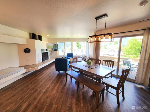 a dining room with furniture a chandelier and wooden floor