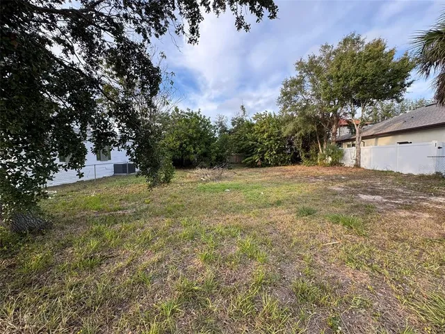 a view of a field with trees in the background