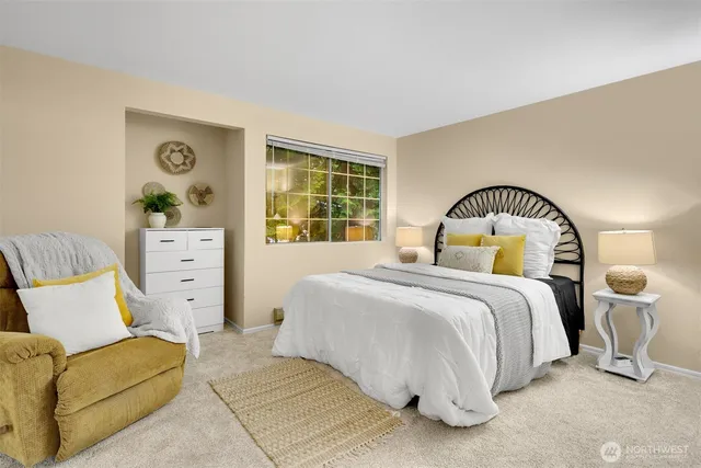 a bedroom with a bed and a large window