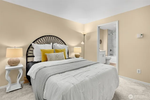 a bedroom with a bed and a large mirror