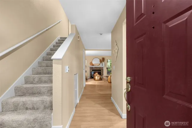 a view of a hallway with white walls and stairs