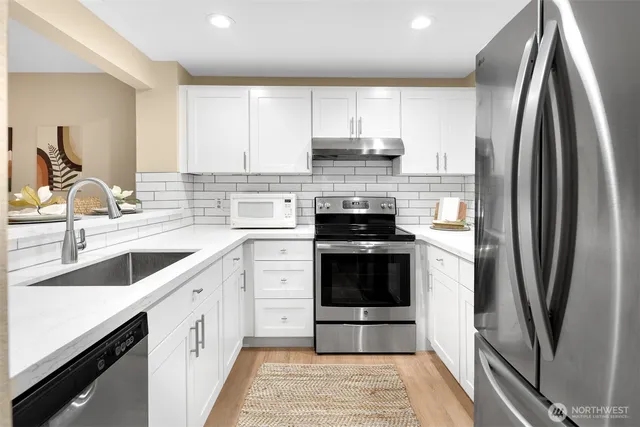 a kitchen with a sink stove and refrigerator