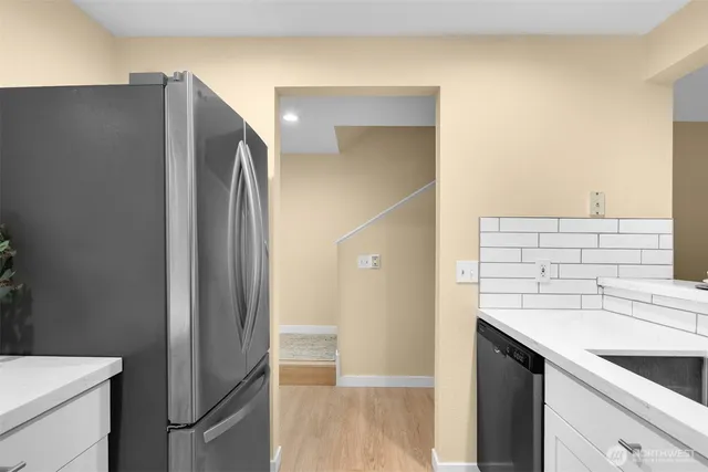 a kitchen with a sink and a refrigerator