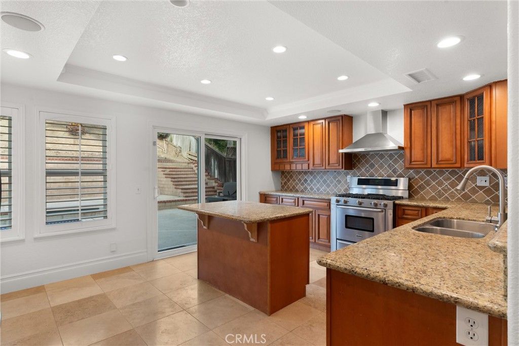 3371 Amy Drive Corona, CA 92882 - Photo 12 of 44 a kitchen with a stove a sink a microwave a center island and a window