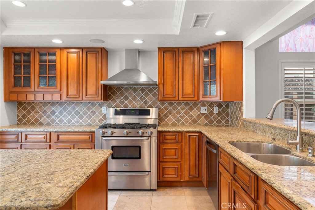 3371 Amy Drive Corona, CA 92882 - Photo 13 of 44 a kitchen with stainless steel appliances granite countertop a stove a sink and a microwave