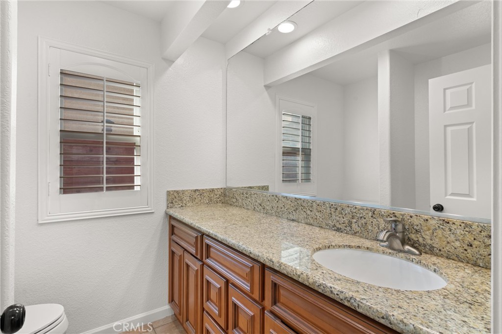 3371 Amy Drive Corona, CA 92882 - Photo 17 of 44 a bathroom with a granite countertop sink and a mirror