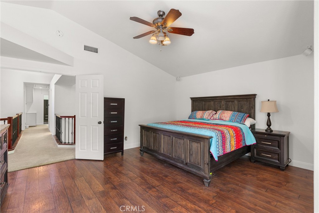 3371 Amy Drive Corona, CA 92882 - Photo 28 of 44 a bedroom with a bed and a chandelier