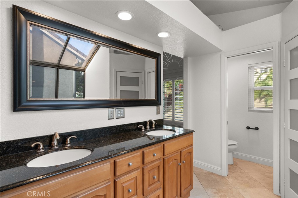 3371 Amy Drive Corona, CA 92882 - Photo 31 of 44 a bathroom with a sink and a mirror