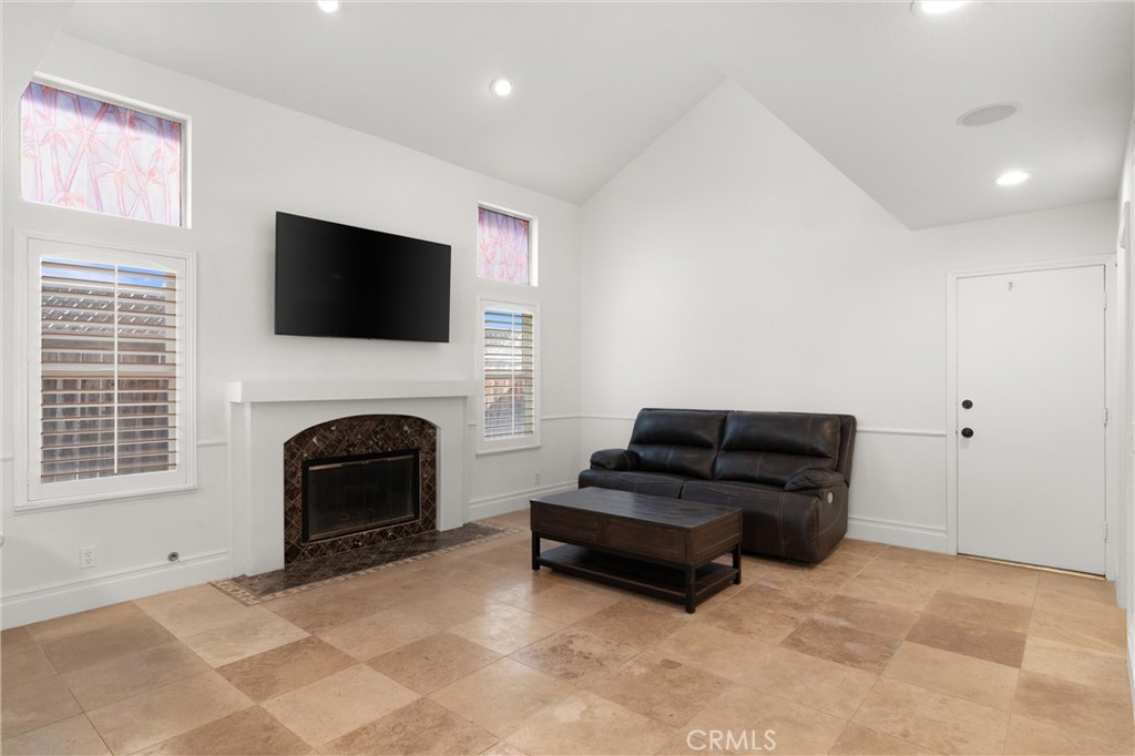 3371 Amy Drive Corona, CA 92882 - Photo 10 of 44 a living room with furniture a flat screen tv and a fireplace