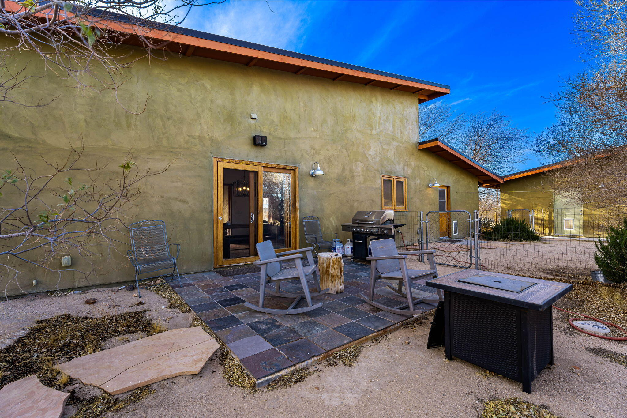 1776 Sunview Avenue Joshua Tree, CA 92252 - Photo 26 of 55 a view of a patio with table and chairs and potted plants