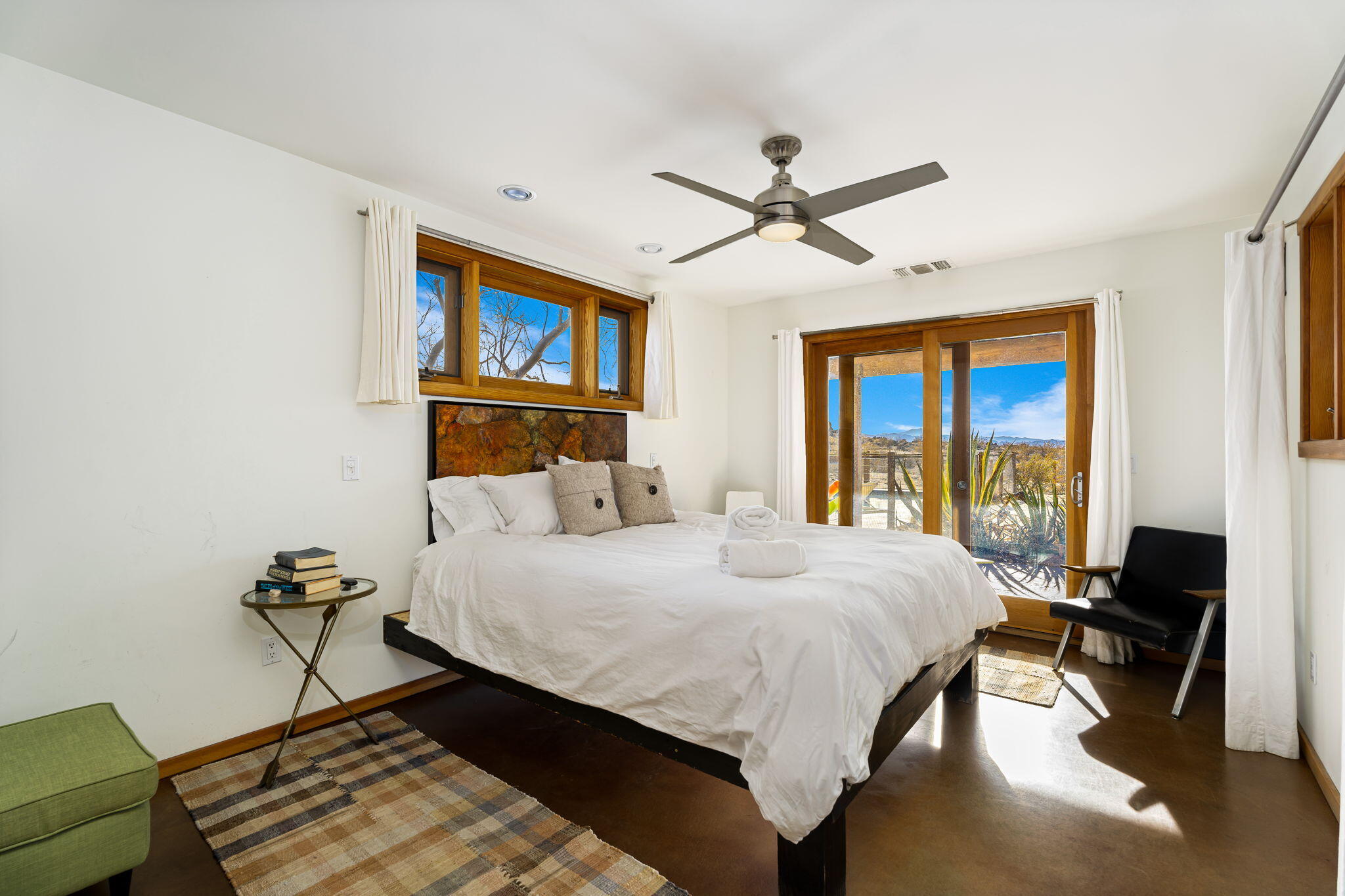 1776 Sunview Avenue Joshua Tree, CA 92252 - Photo 30 of 55 a bedroom with a bed and a chandelier