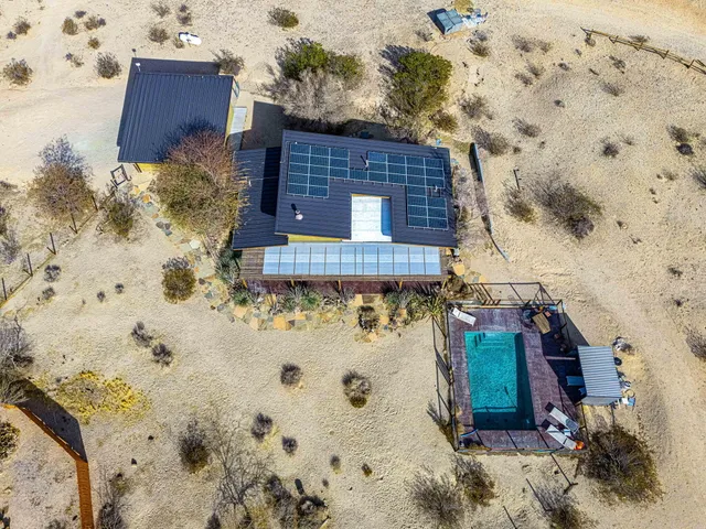 a view of a wooden house with a yard