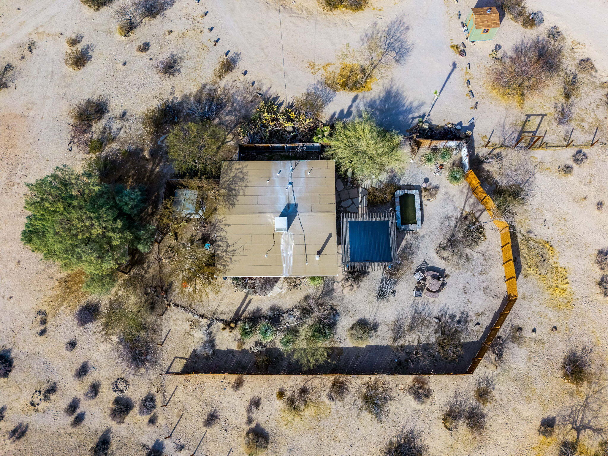 1776 Sunview Avenue Joshua Tree, CA 92252 - Photo 7 of 55 a view of a wooden house with a yard