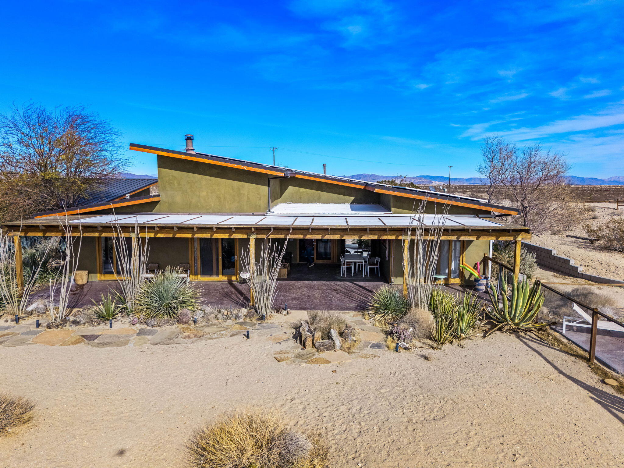 1776 Sunview Avenue Joshua Tree, CA 92252 - Photo 10 of 55 a front view of a house with a yard