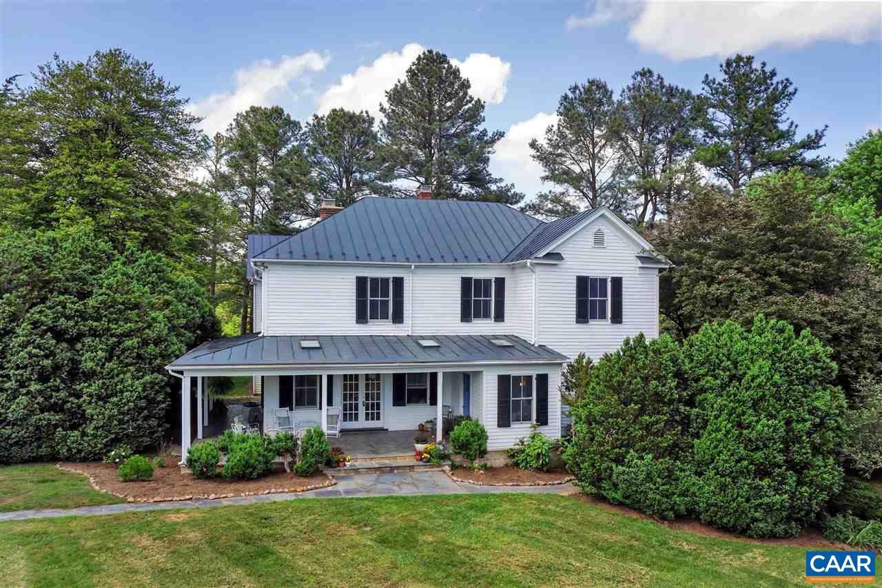 a aerial view of a house with garden and trees