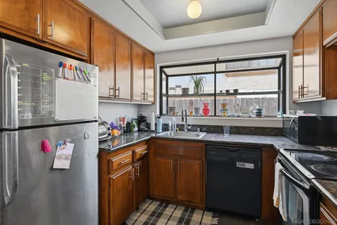 a kitchen with stainless steel appliances granite countertop a sink stove and cabinets