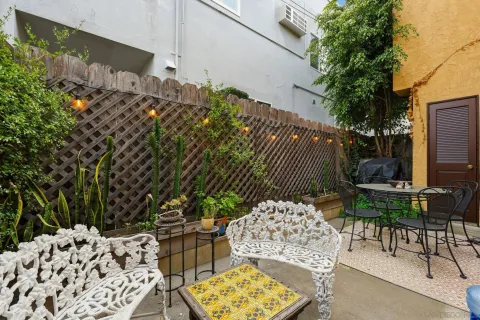 a backyard of a house with table and chairs