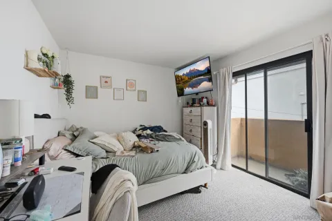 a bedroom with a bed and a desk