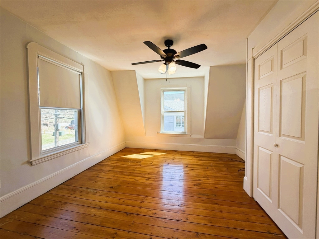 481 Humphrey Street Swampscott, MA 01907 - Photo 15 of 28 a view of empty room with wooden floor and fan