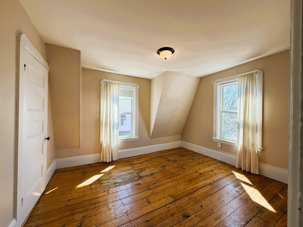 481 Humphrey Street Swampscott, MA 01907 - Photo 17 of 28 an empty room with wooden floor and windows