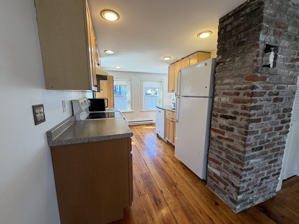481 Humphrey Street Swampscott, MA 01907 - Photo 22 of 28 a kitchen with a refrigerator and a stove