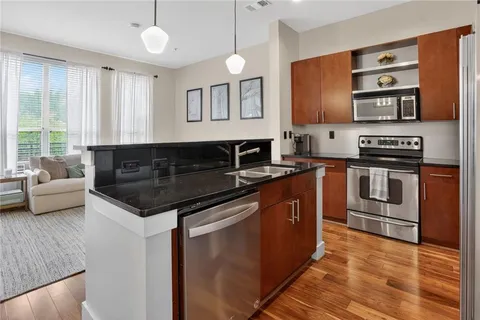 a kitchen with stainless steel appliances granite countertop a stove and a sink