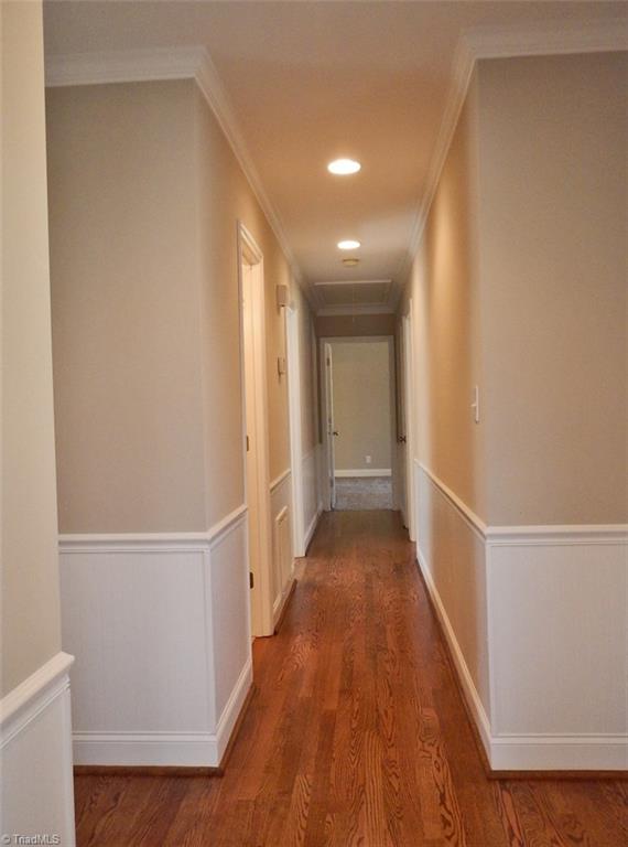 8007 Eastridge Road Oak Ridge, NC 27310 - Photo 12 of 29 Hardwoods continue down the bedroom hallway. There is beaded board wainscoting & recessed lighting.