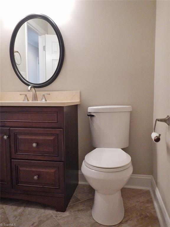 8007 Eastridge Road Oak Ridge, NC 27310 - Photo 13 of 29 The Hall Bathroom has been updated with tile flooring set on a diagonal & a comfort level vanity with undercount sink.