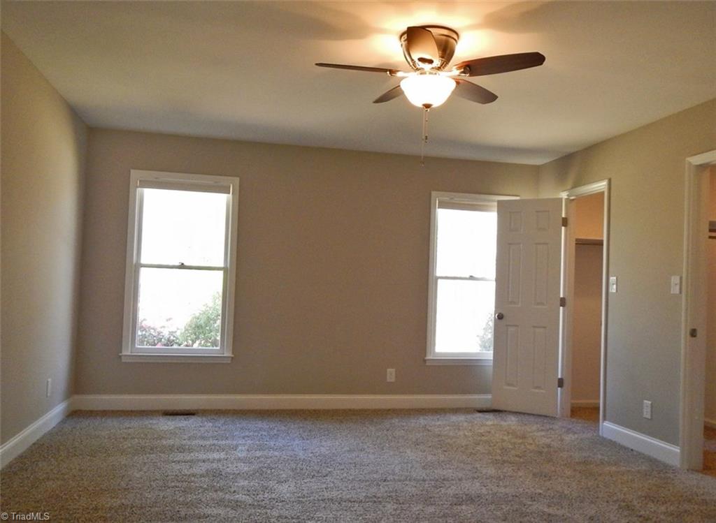 8007 Eastridge Road Oak Ridge, NC 27310 - Photo 14 of 29 The Master Bedroom is carpeted. I has 2 large windows overlooking the front of the property & it also has a ceiling fan.