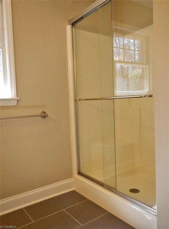 8007 Eastridge Road Oak Ridge, NC 27310 - Photo 18 of 29 The Master Bathroom has a large walk-in shower with a "rain shower" shower head.