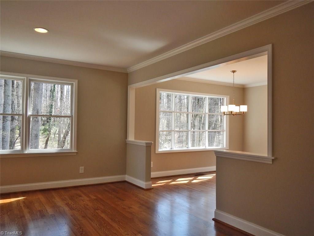 8007 Eastridge Road Oak Ridge, NC 27310 - Photo 3 of 29 The Living Room & Dining Room open to each other. Hardwood floors flow from the entry through the living/ding room.