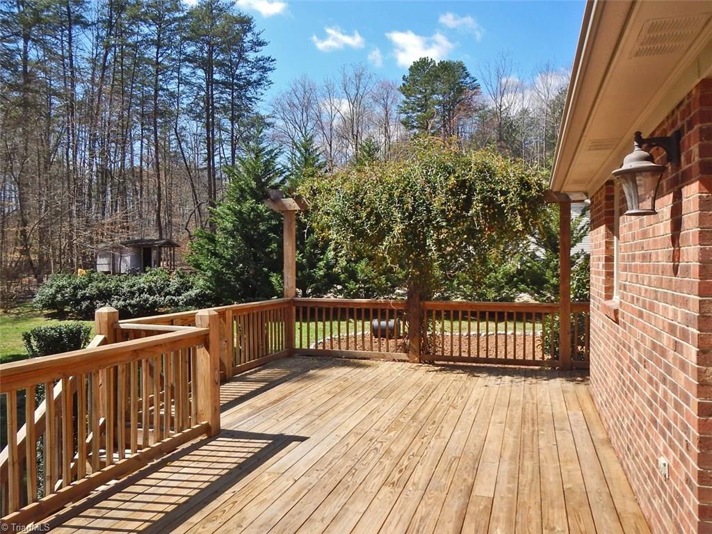 8007 Eastridge Road Oak Ridge, NC 27310 - Photo 23 of 29 The deck spans the area from the laundry to the dining room providing plenty of space for outdoor activities.
