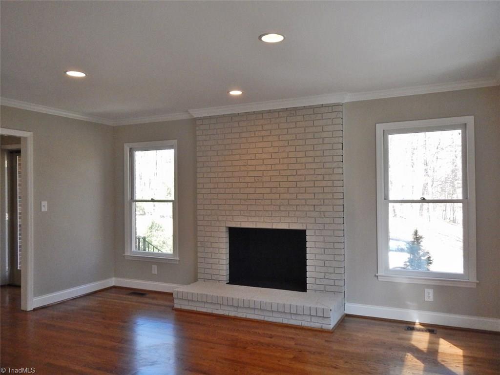 8007 Eastridge Road Oak Ridge, NC 27310 - Photo 4 of 29 The painted masonry fireplace is the focal point of the Living Room. Recessed lighting is found through out the house.
