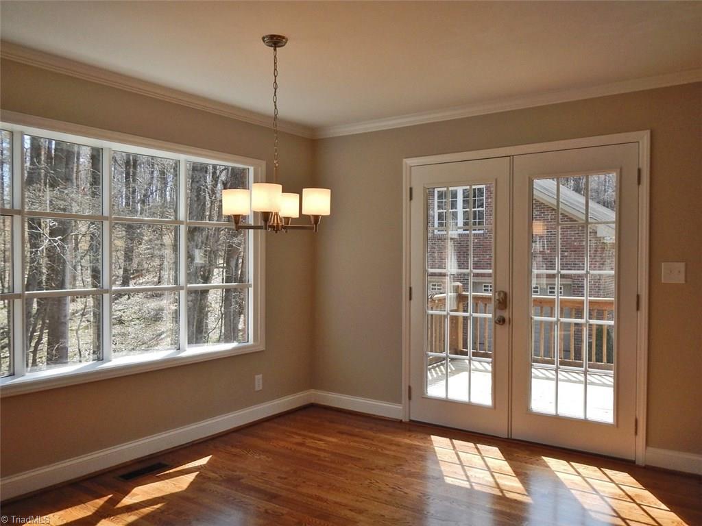 8007 Eastridge Road Oak Ridge, NC 27310 - Photo 6 of 29 The Dining Room features a big bow window & French doors leading to the deck & back yard.