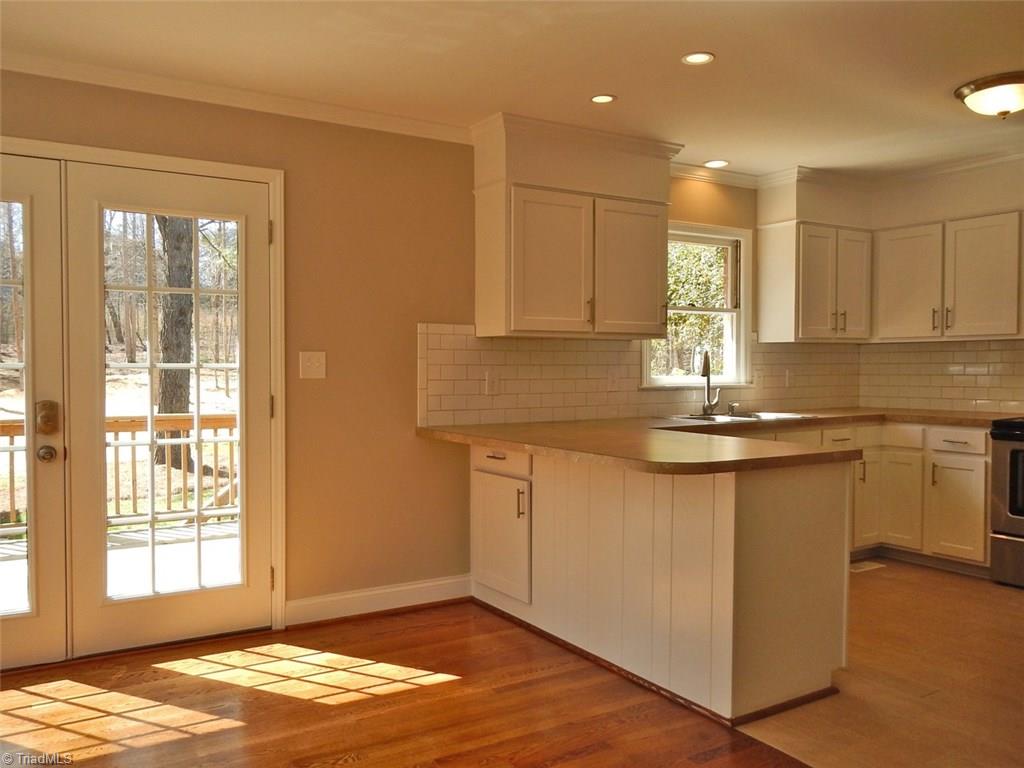 8007 Eastridge Road Oak Ridge, NC 27310 - Photo 7 of 29 The Kitchen is open to the Dining Room. A peninsula countertop has space for pull-up chairs.
