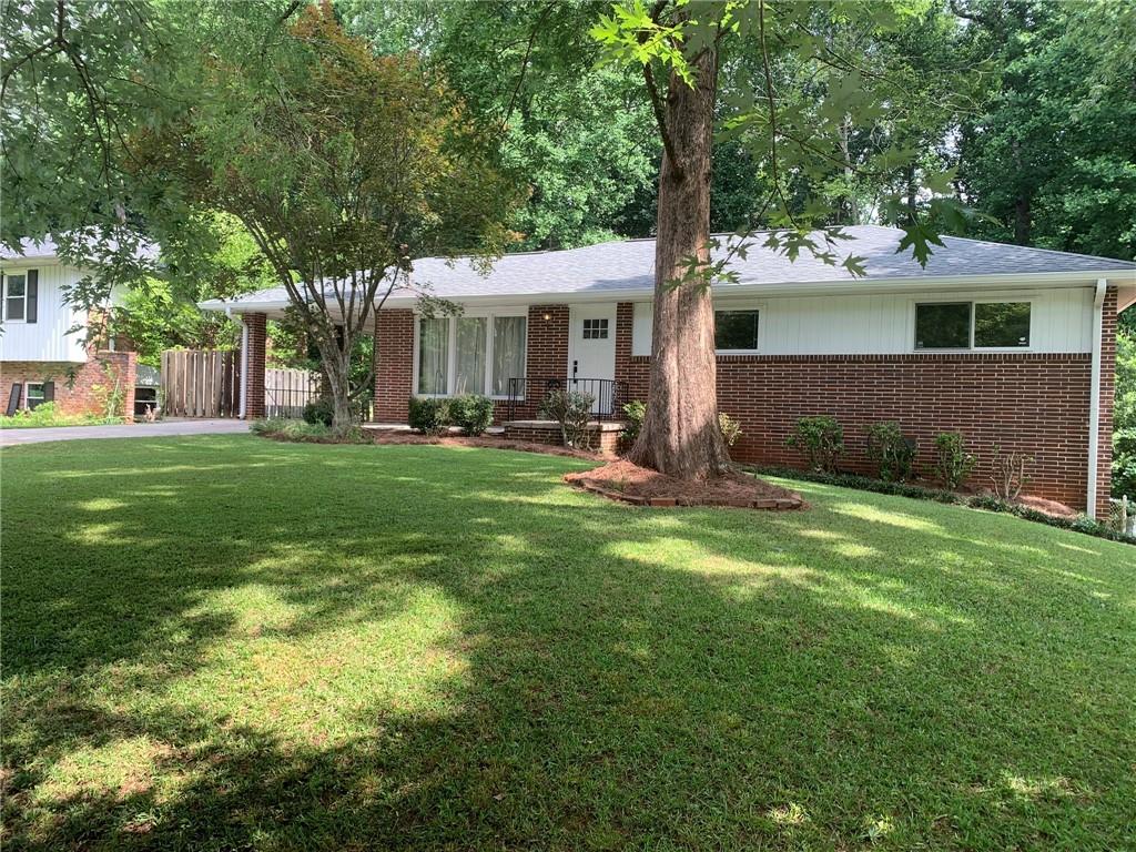 Mostly-level front yard and easy access to walk-out basement from both sides - gentle slope adds potential for accessible sidewalk on the right.