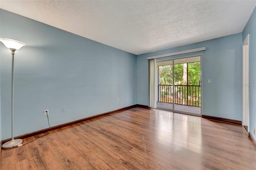 13300 Walsingham Road, Unit 56 Largo, FL 33774 - Photo 25 of 35 a view of an empty room with wooden floor and a window