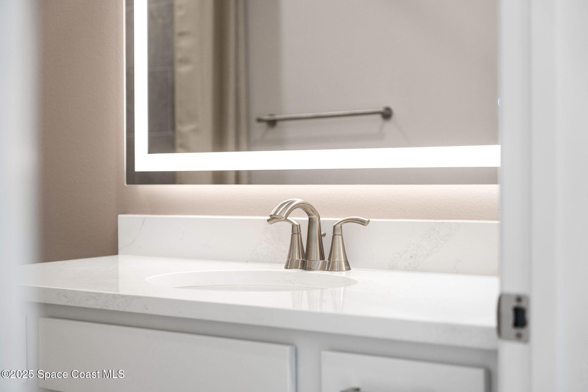 225 1st Street Cocoa, FL 32922 - Photo 13 of 64 a bathroom with a sink and a mirror