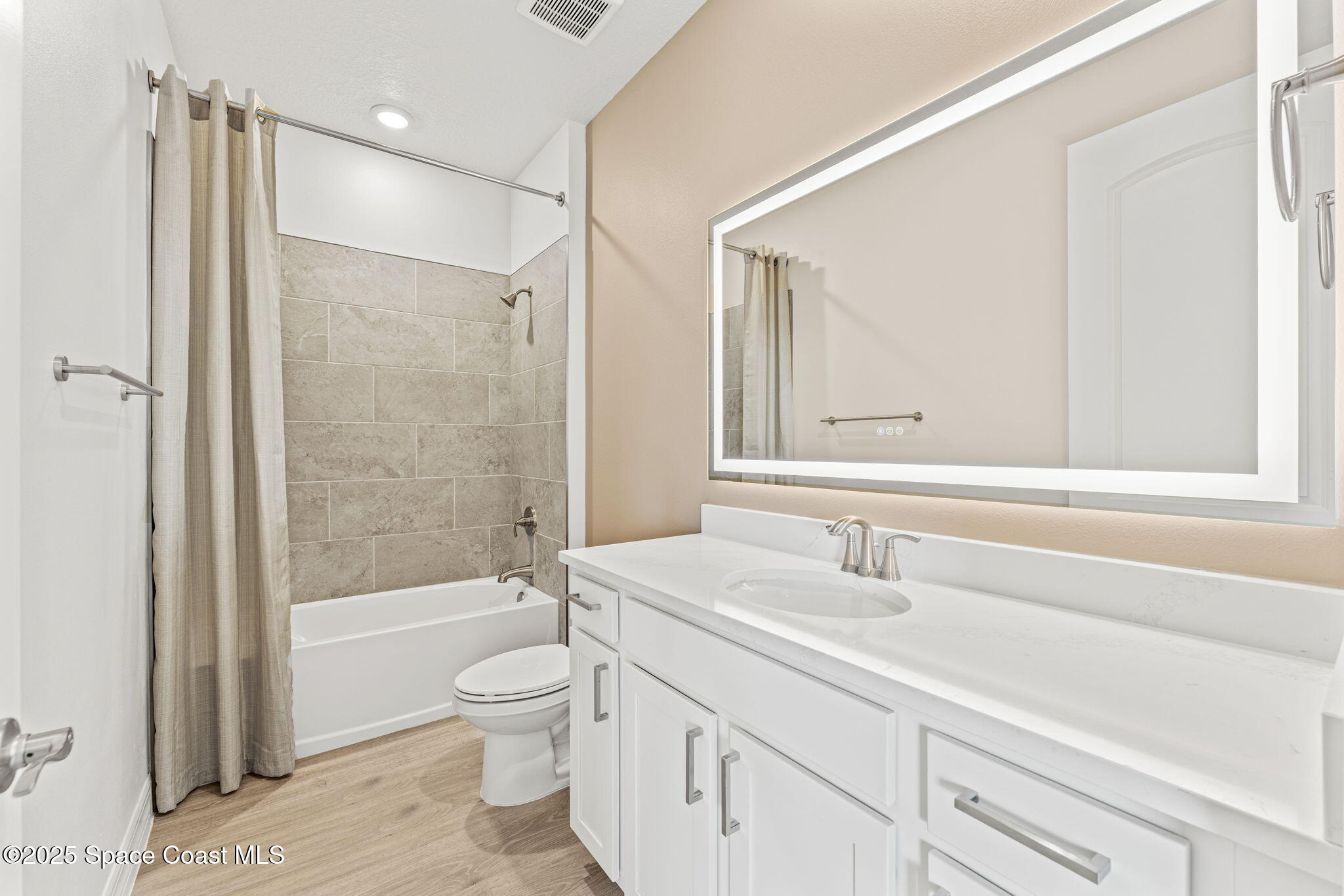 225 1st Street Cocoa, FL 32922 - Photo 14 of 64 a bathroom with a granite countertop sink a toilet and shower