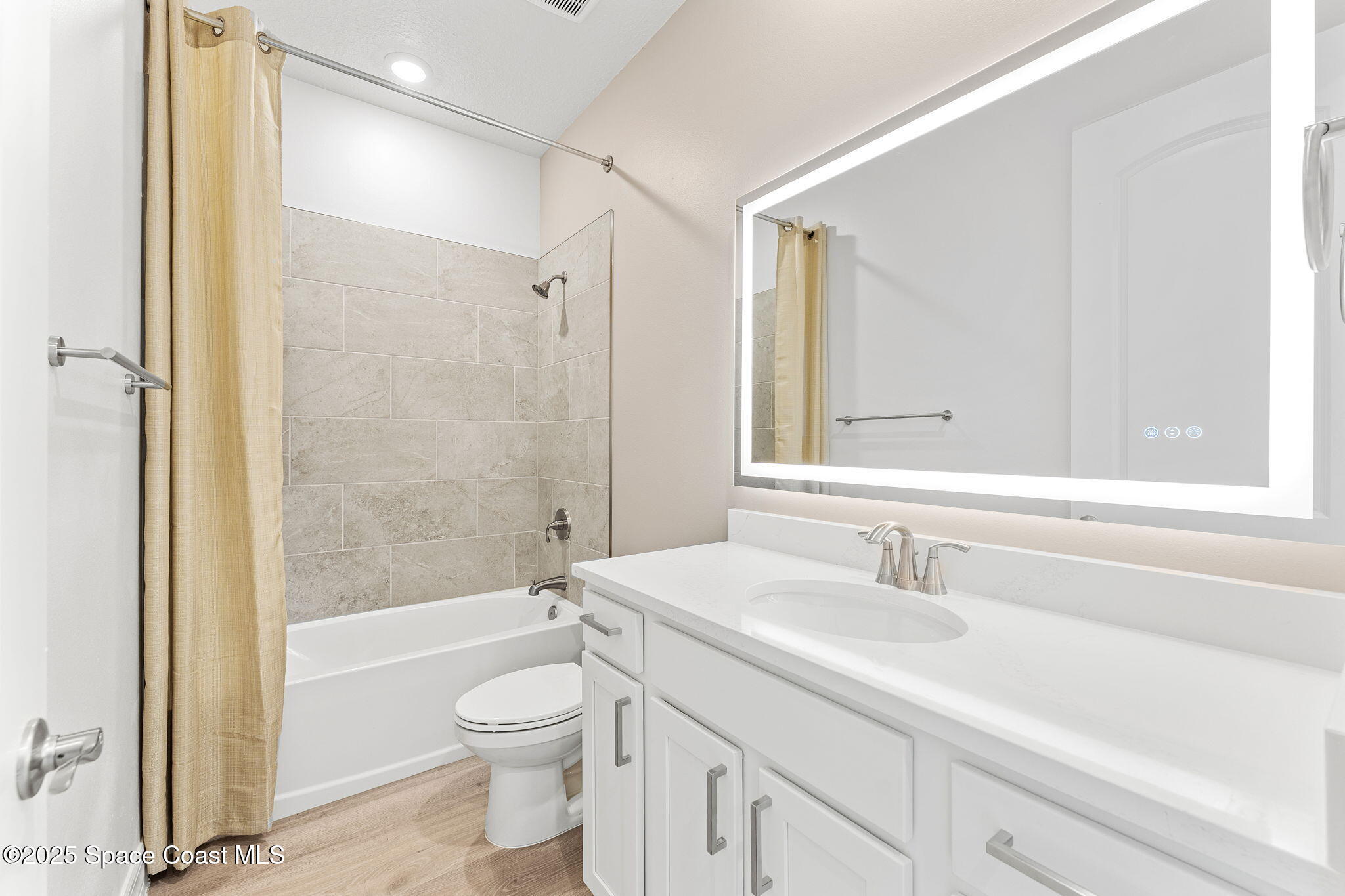 225 1st Street Cocoa, FL 32922 - Photo 19 of 64 a bathroom with a sink a toilet and shower