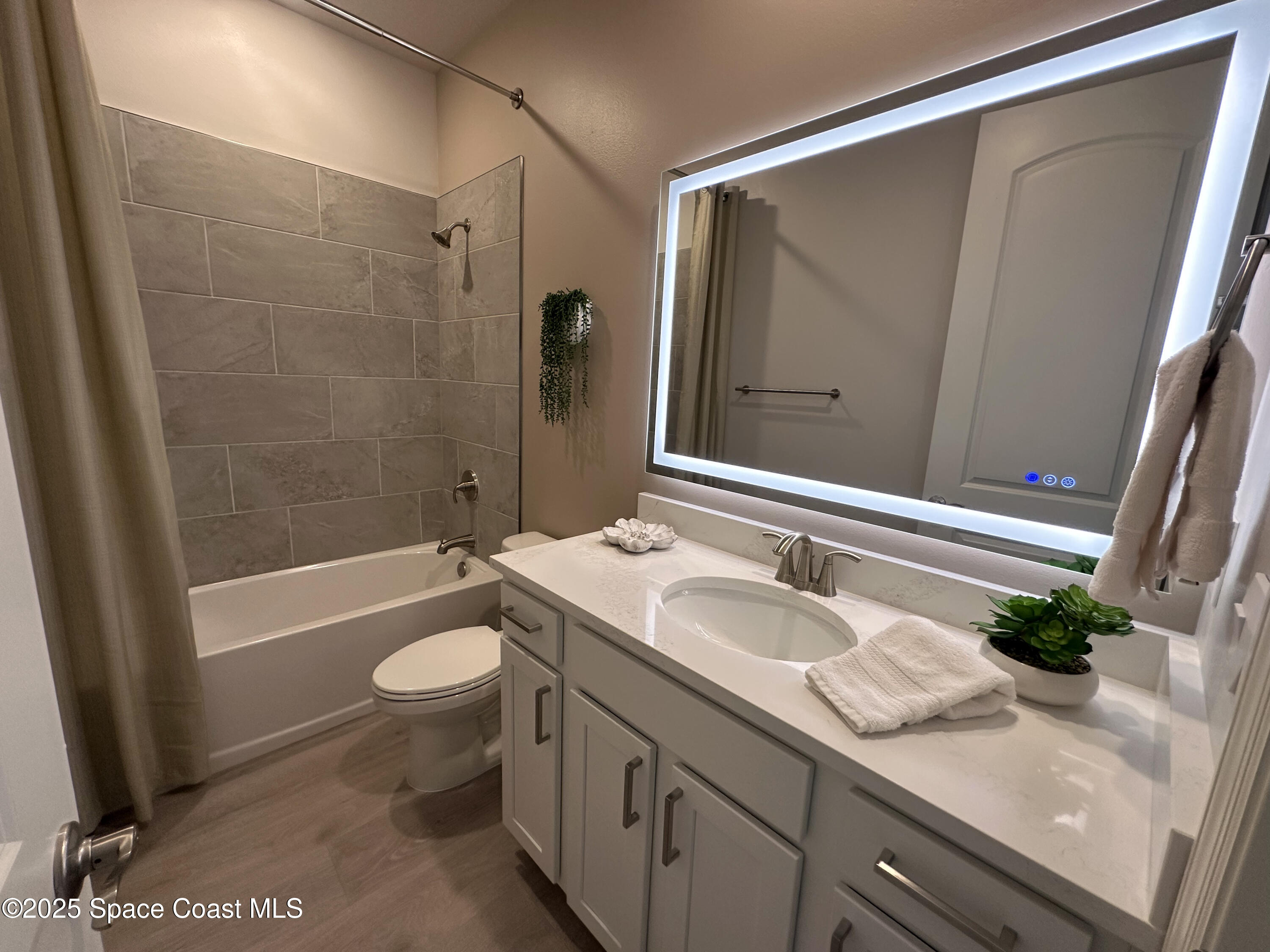 225 1st Street Cocoa, FL 32922 - Photo 20 of 64 a bathroom with a granite countertop sink toilet and shower