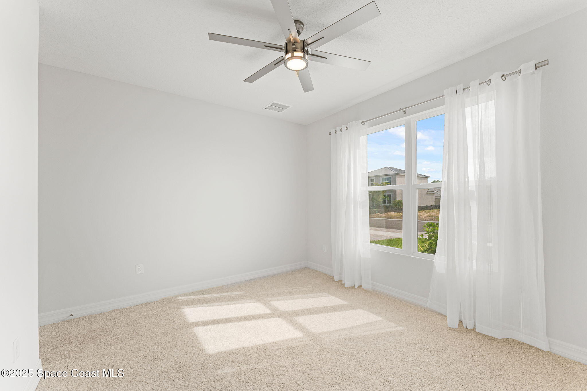 225 1st Street Cocoa, FL 32922 - Photo 21 of 64 an empty room with windows and fan