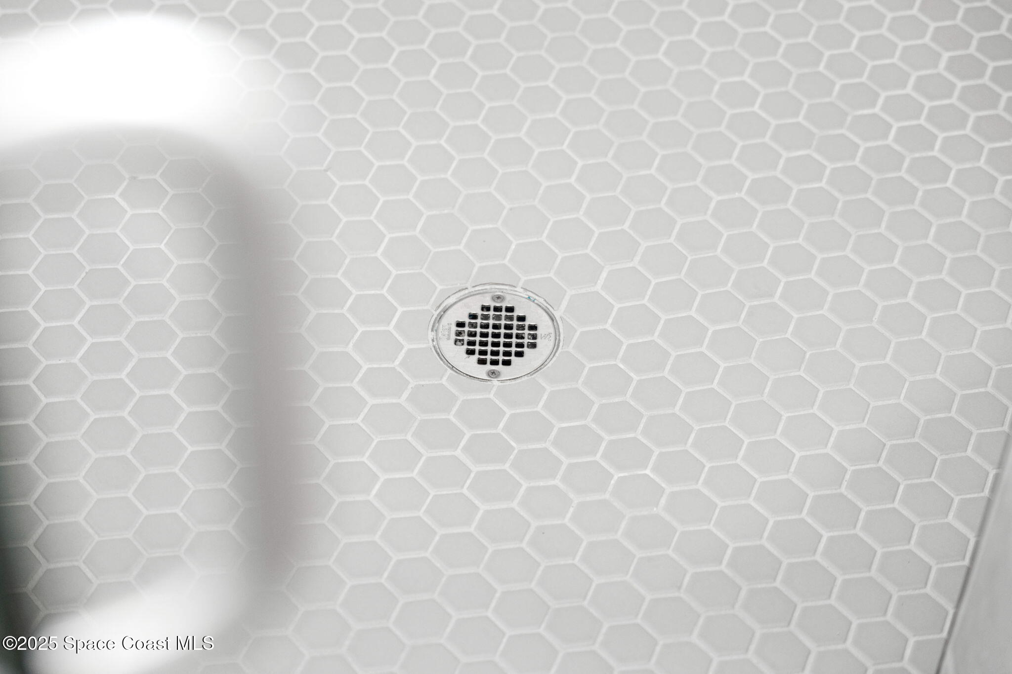 225 1st Street Cocoa, FL 32922 - Photo 24 of 64 a bathroom with a white wall and a bathtub