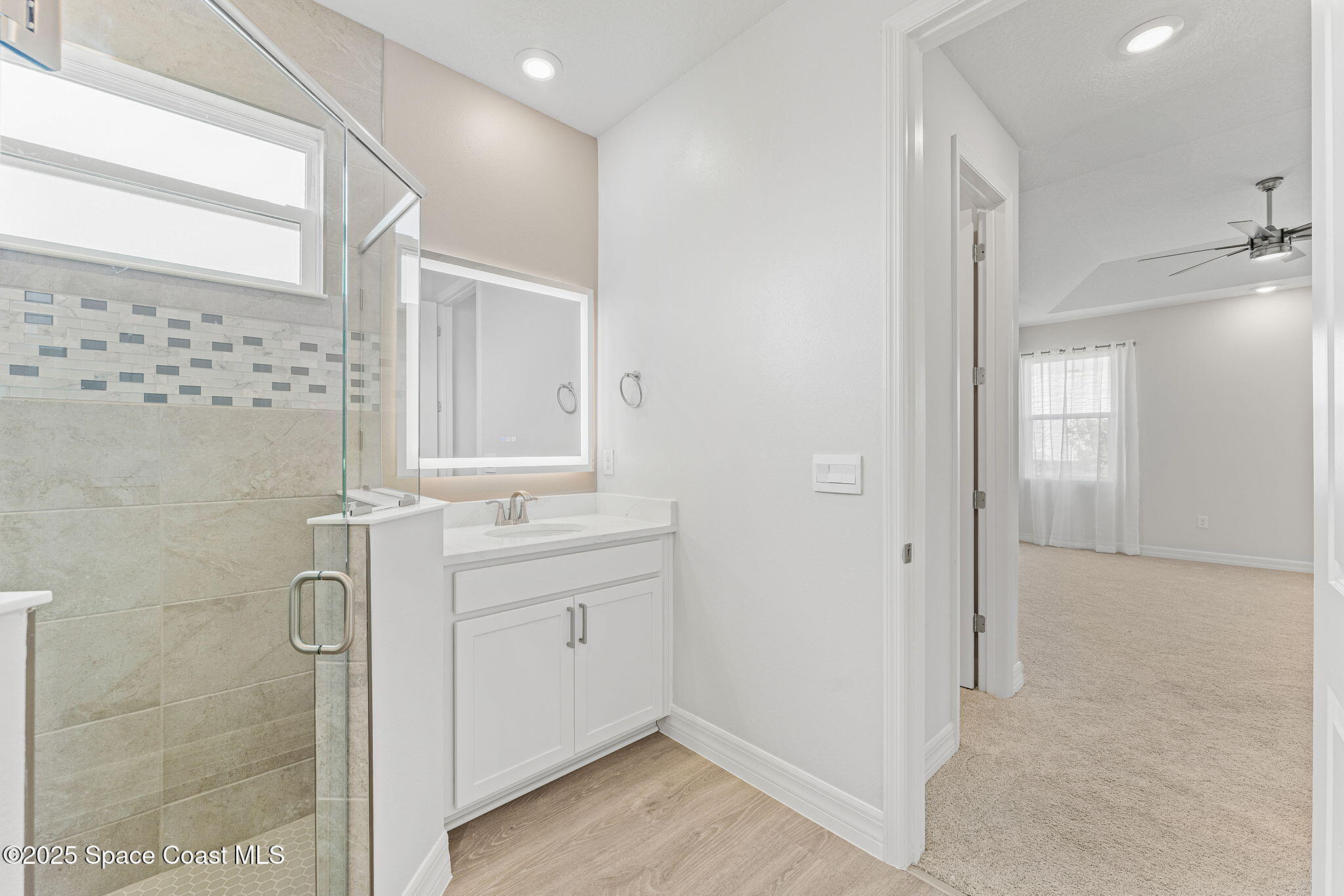 225 1st Street Cocoa, FL 32922 - Photo 29 of 64 a bathroom with a double vanity sink a mirror and a shower