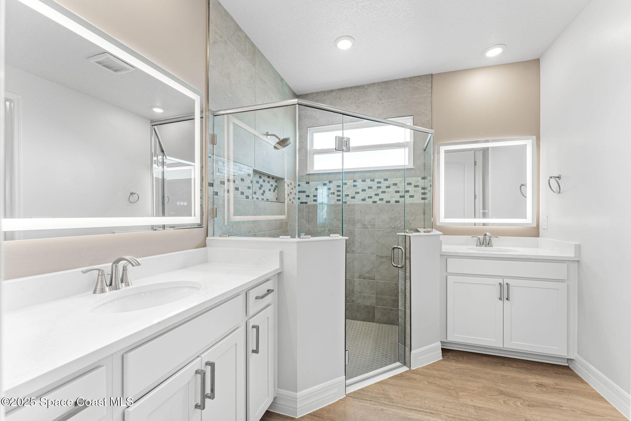 225 1st Street Cocoa, FL 32922 - Photo 32 of 64 a bathroom with a sink double vanity and a shower