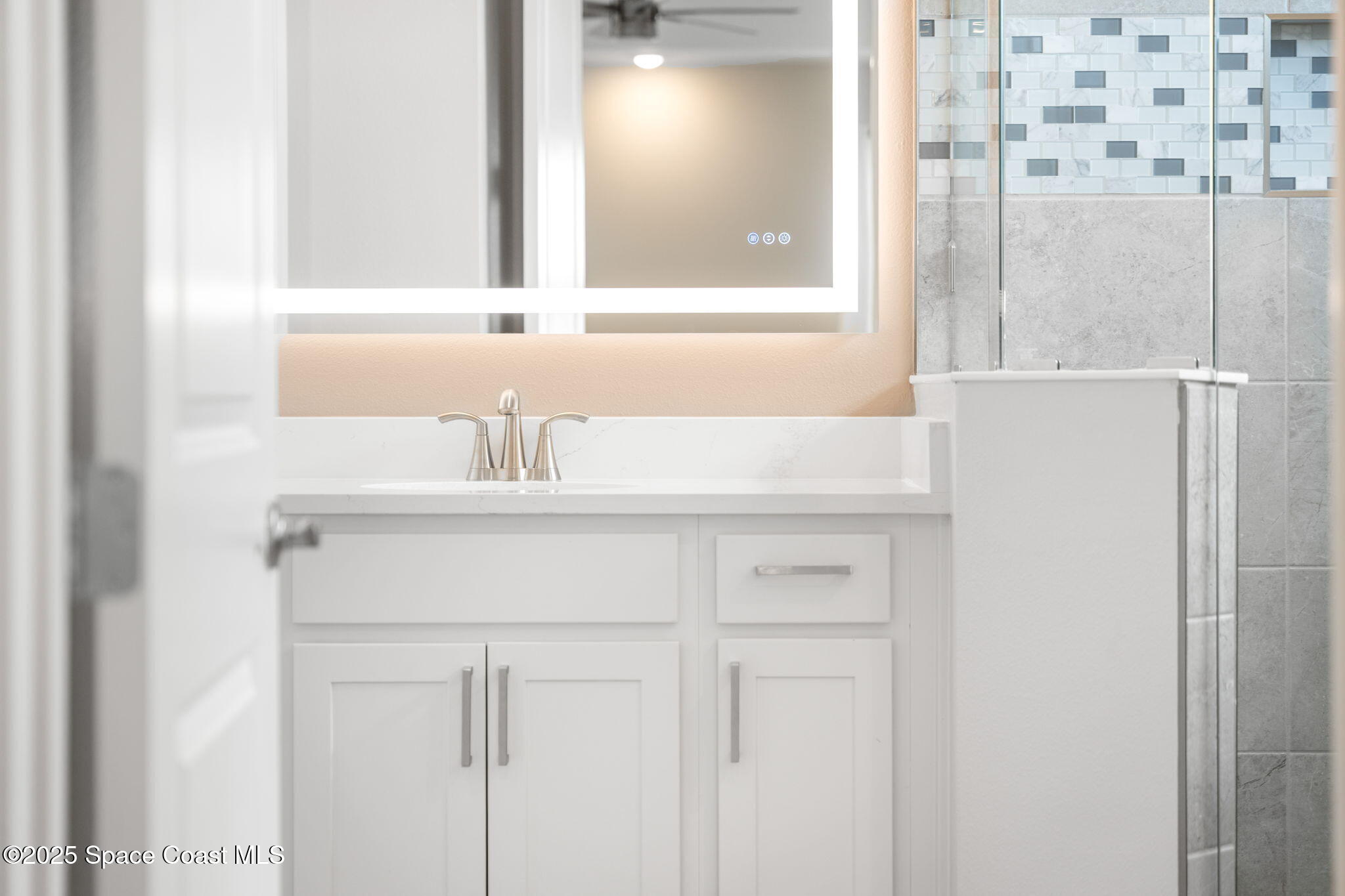 225 1st Street Cocoa, FL 32922 - Photo 33 of 64 a bathroom with a sink and a mirror