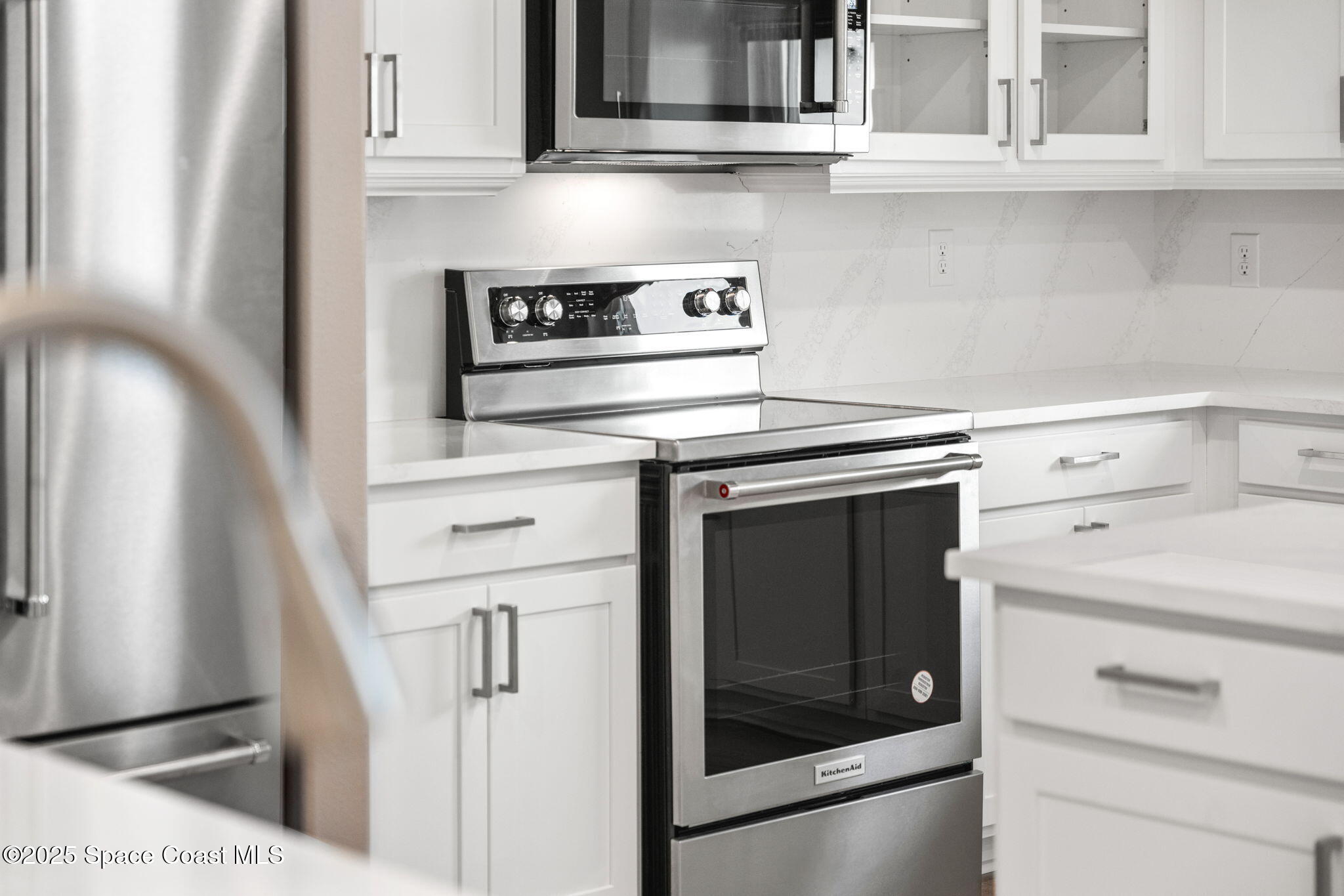 225 1st Street Cocoa, FL 32922 - Photo 48 of 64 a kitchen with cabinets and a stove