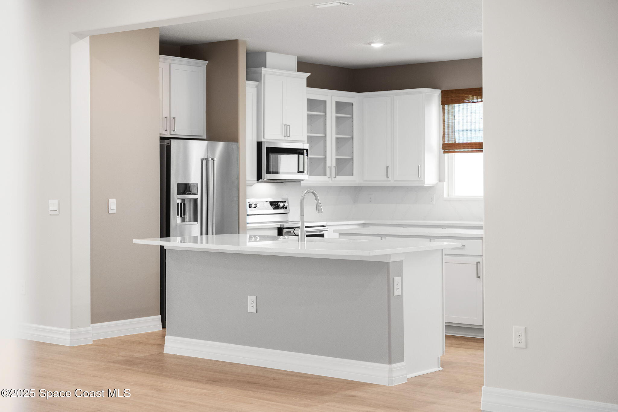 225 1st Street Cocoa, FL 32922 - Photo 50 of 64 a kitchen with stainless steel appliances a sink stove and refrigerator