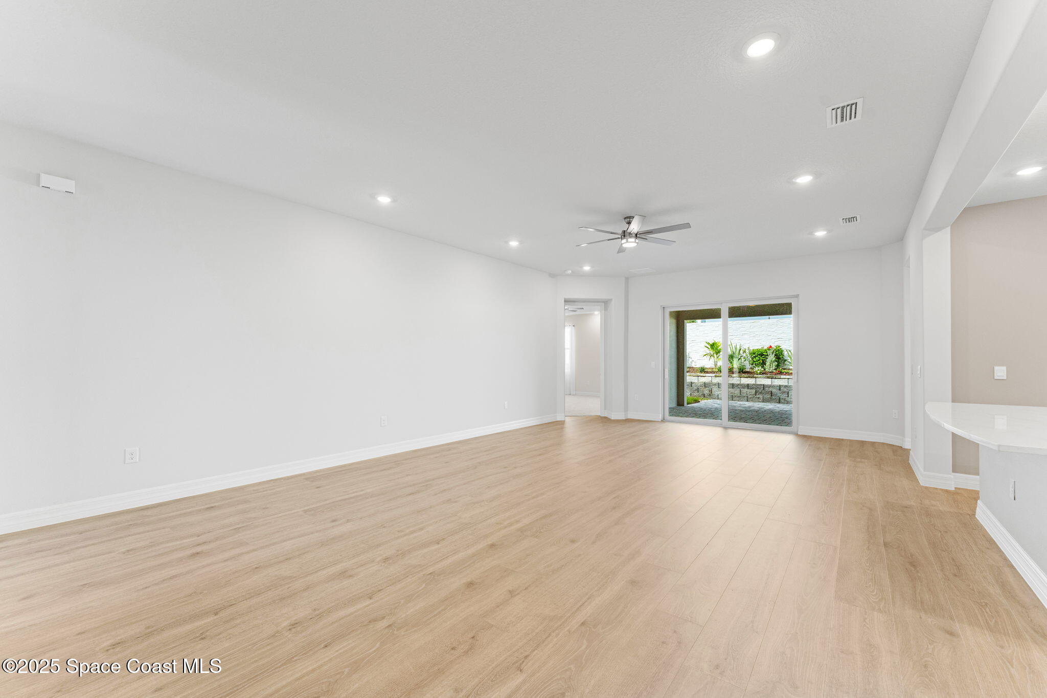 225 1st Street Cocoa, FL 32922 - Photo 54 of 64 an empty room with wooden floor and windows