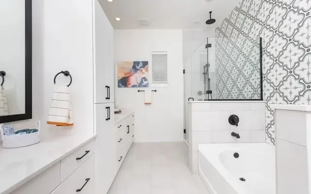 a bathroom with a bathtub sink and mirror